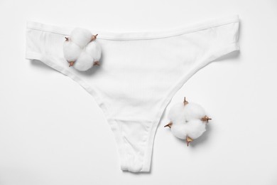 Photo of Stylish women's underwear and cotton flowers on white background, flat lay