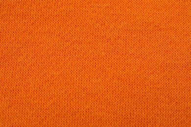 Photo of Texture of soft orange fabric as background, top view