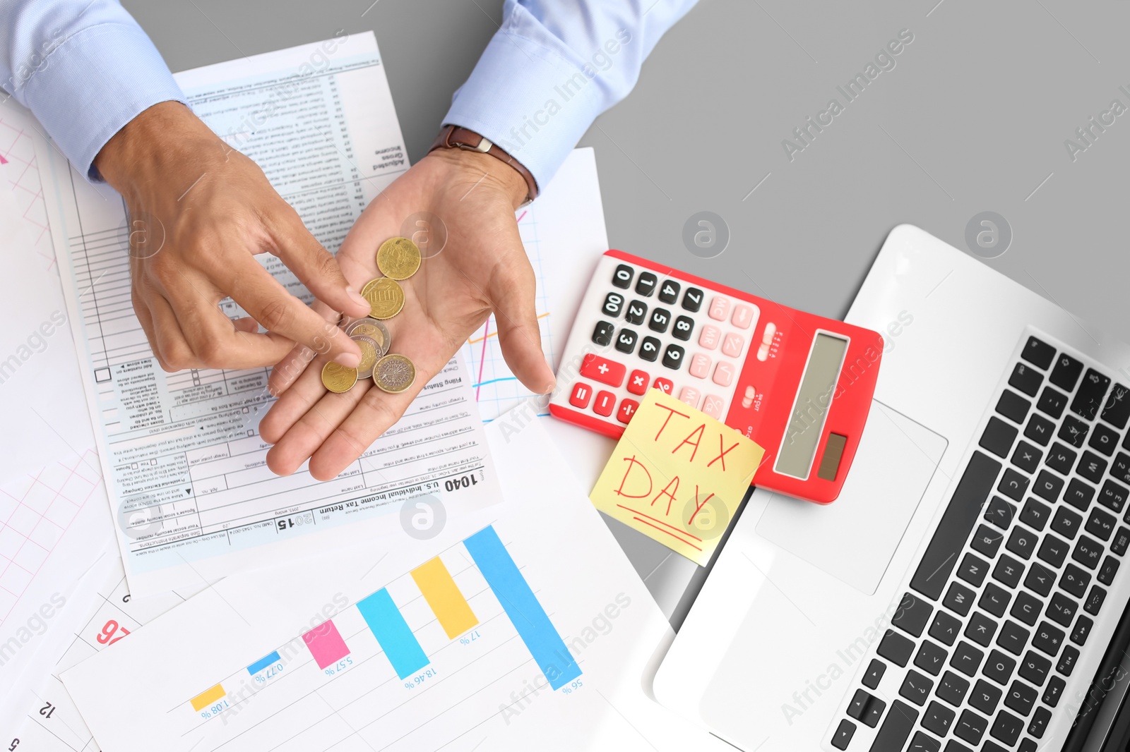 Photo of Tax accountant with money and documents at table