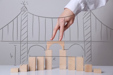 Image of Woman walking over drawn bridge with her fingers, closeup