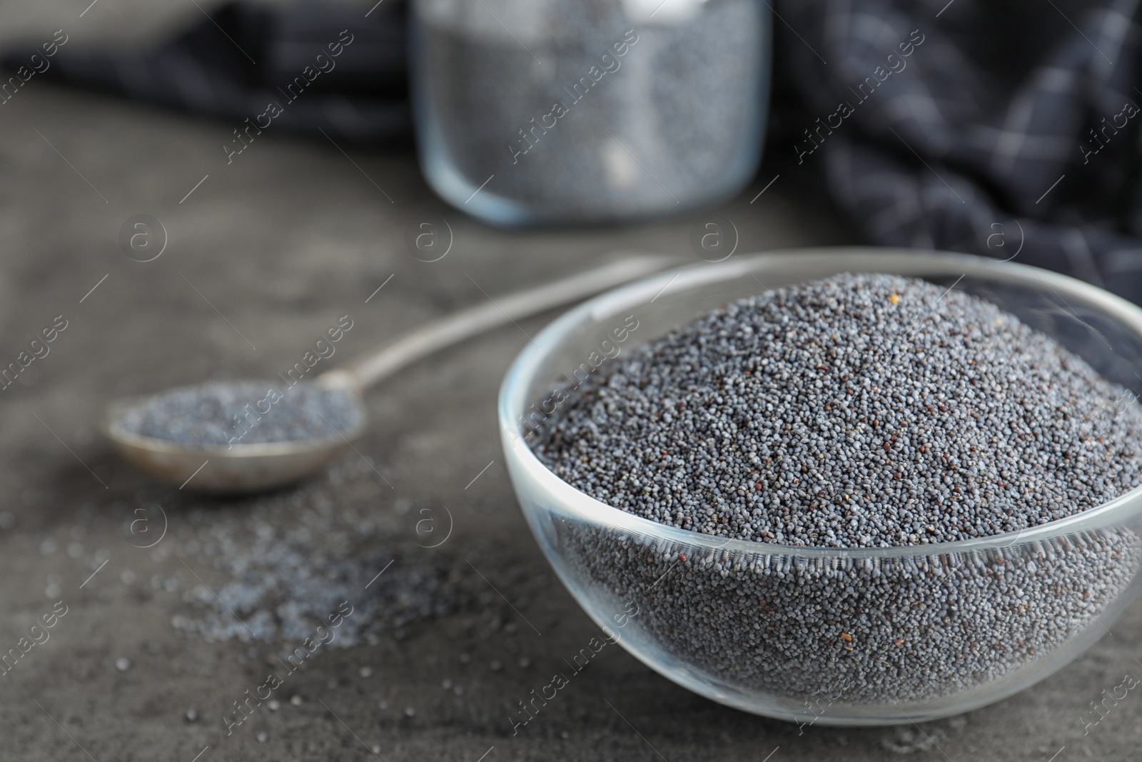 Photo of Poppy seeds in bowl on table. Space for text