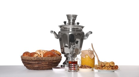 Photo of Traditional Russian samovar with treats isolated on white