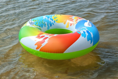 Photo of Bright inflatable ring floating on sea water. Summer vacation