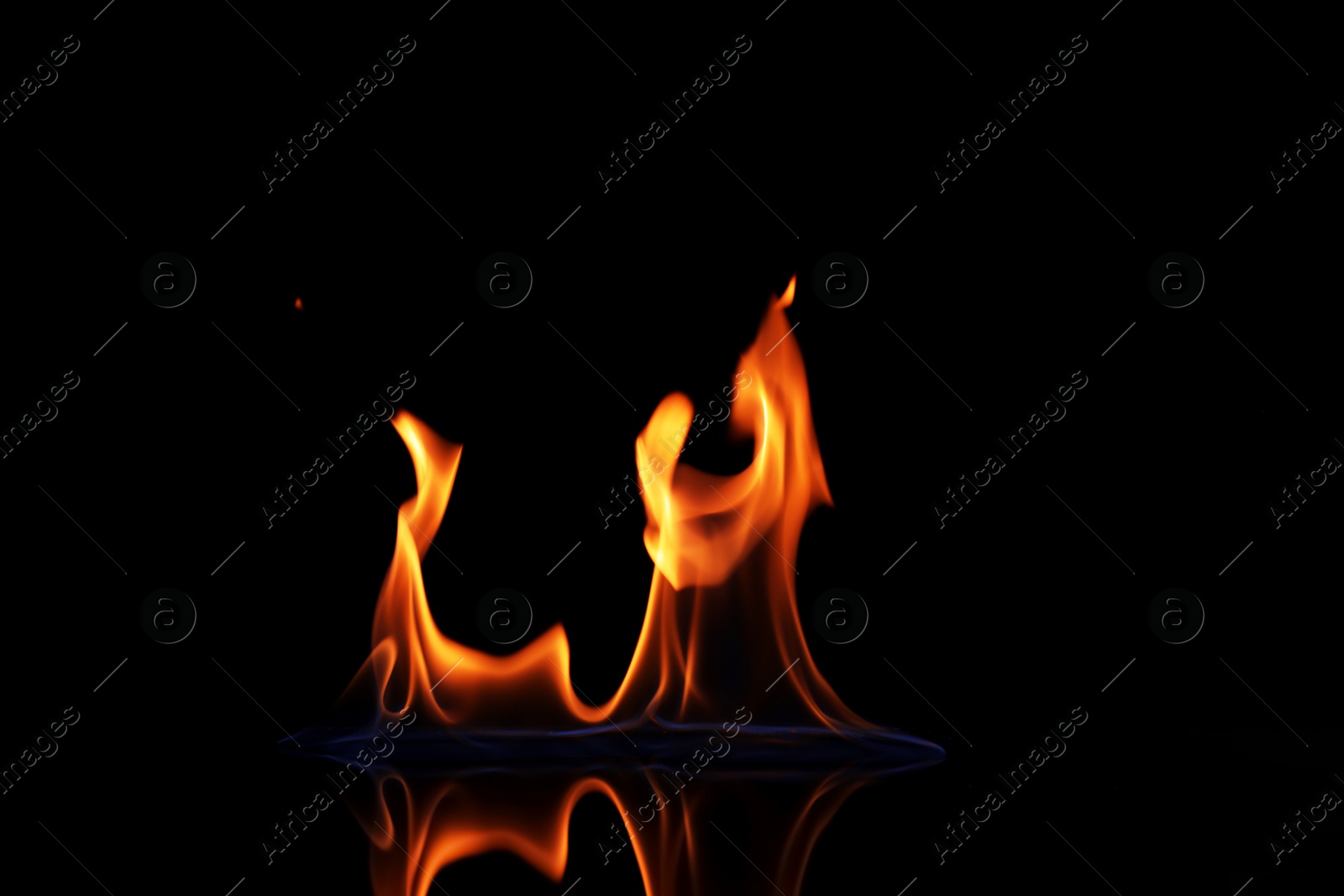 Photo of Beautiful view of flaming vodka on black background