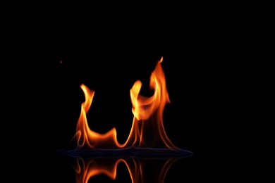 Photo of Beautiful view of flaming vodka on black background