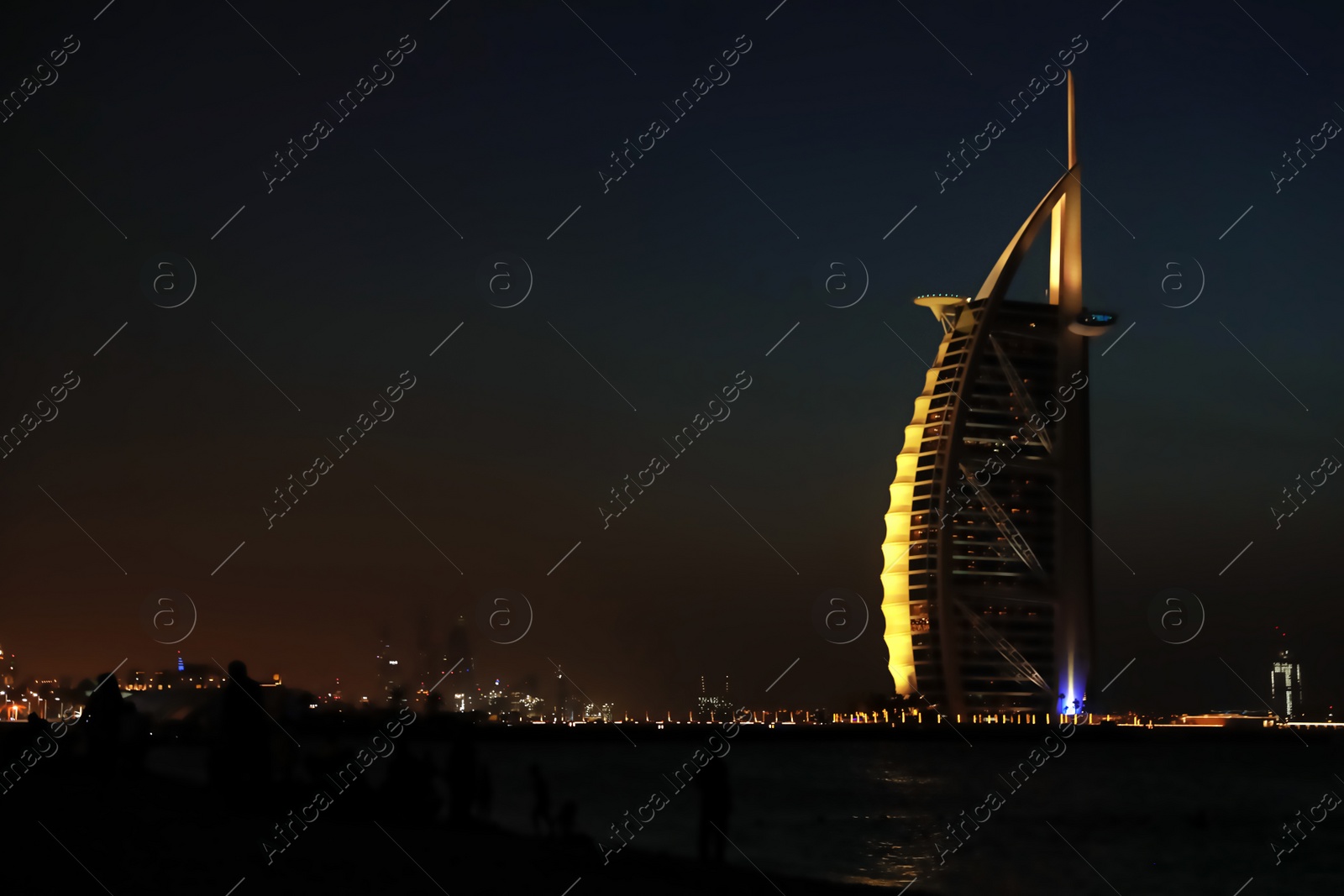 Photo of DUBAI, UNITED ARAB EMIRATES - NOVEMBER 03, 2018: Night landscape with illuminated Burj Al Arab