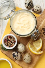 Photo of Delicious homemade mayonnaise, spices and ingredients on white wooden table, flat lay