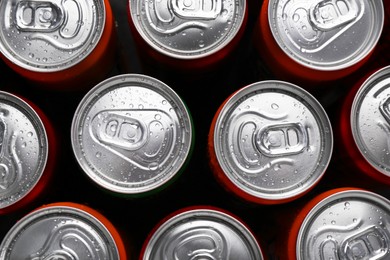 Photo of Energy drink in wet cans, top view. Functional beverage