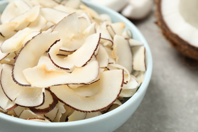 Fresh delicious coconut chips in bowl, closeup