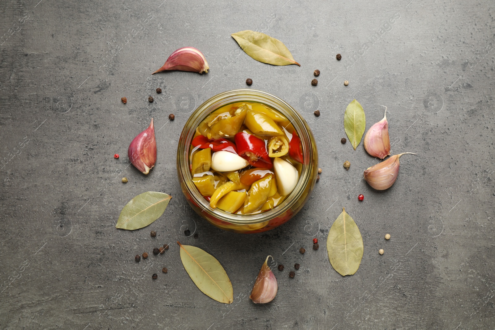 Photo of Flat lay composition with pickled peppers on grey table