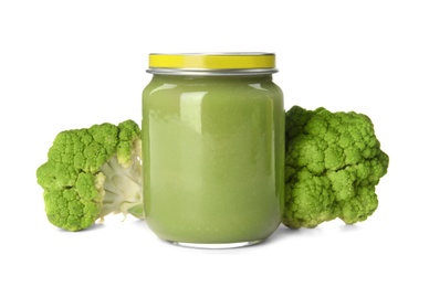 Photo of Jar with healthy baby food and broccoli on white background