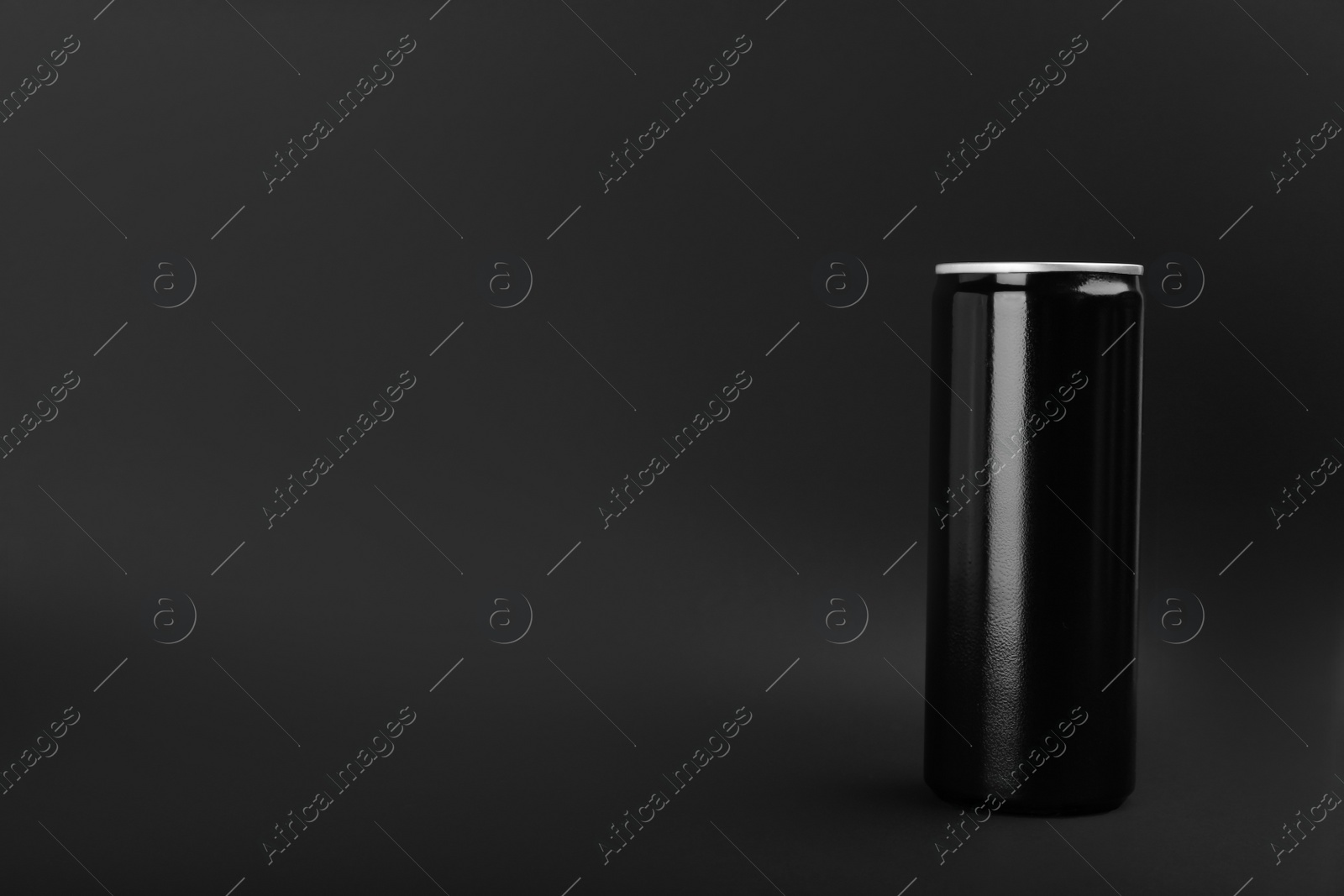 Photo of Can of energy drink on black background. Space for text
