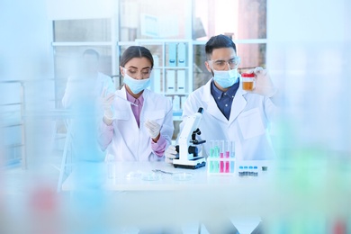 Young scientists working in laboratory. Chemical analysis