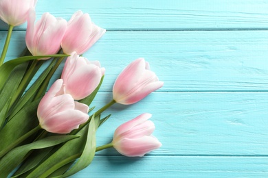 Beautiful tulips for Mother's Day on wooden background, top view