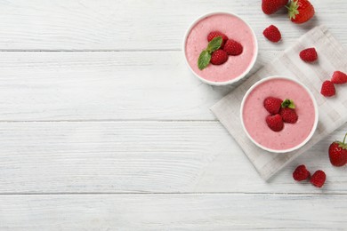 Delicious raspberry mousse with mint on white wooden table, flat lay. Space for text