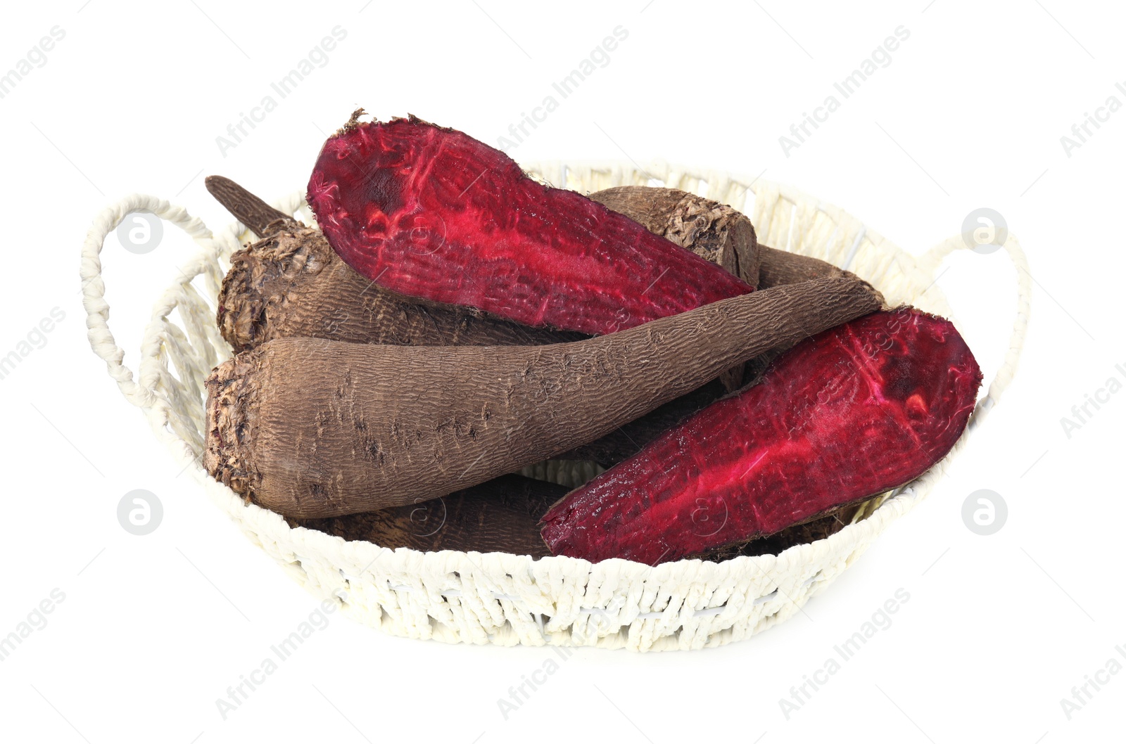 Photo of Whole and cut red beets in basket isolated on white