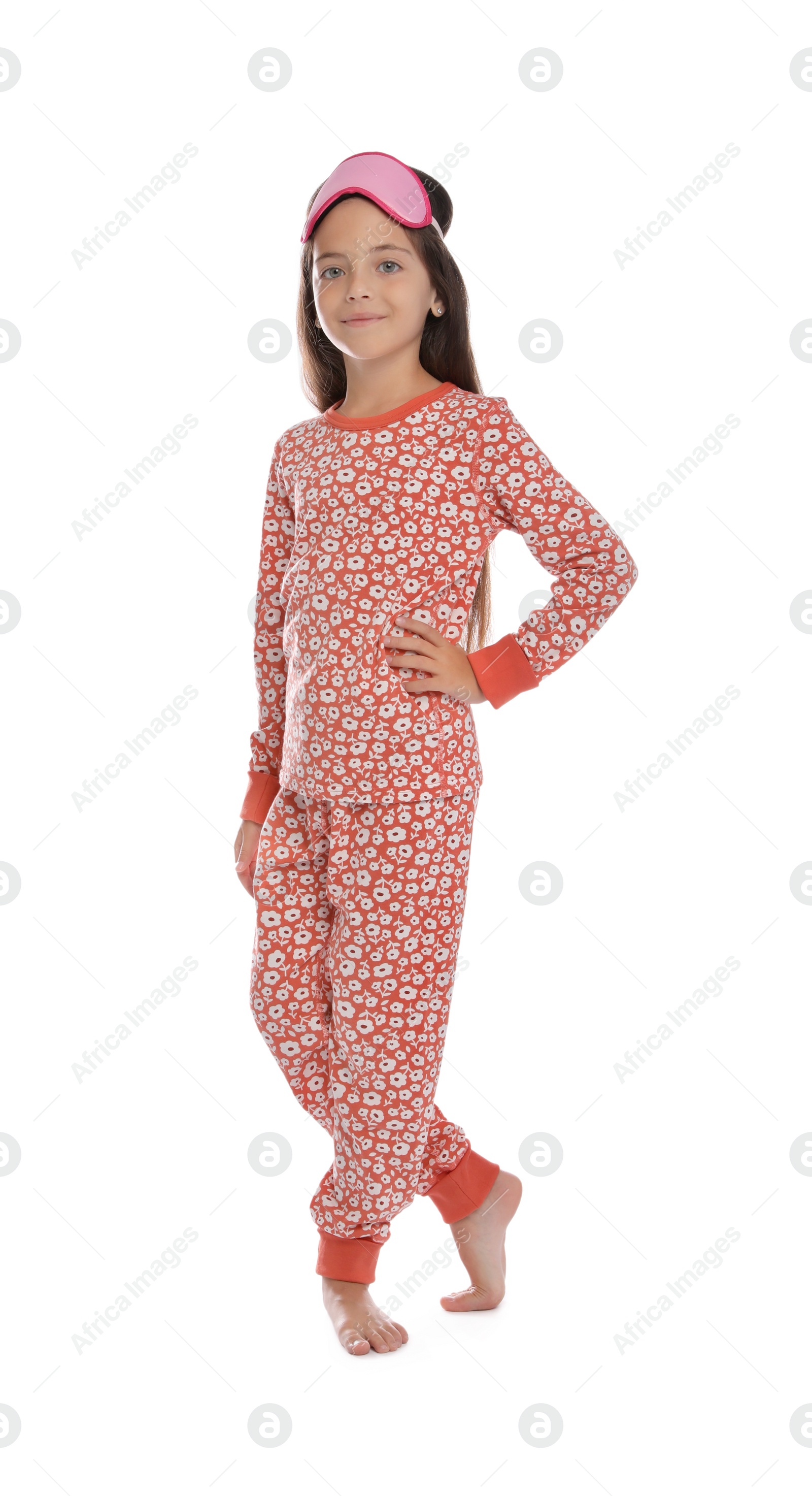 Photo of Cute girl wearing pajamas and sleeping mask on white background