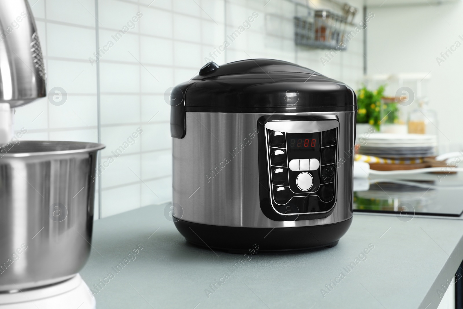 Photo of Modern multi cooker on table in kitchen