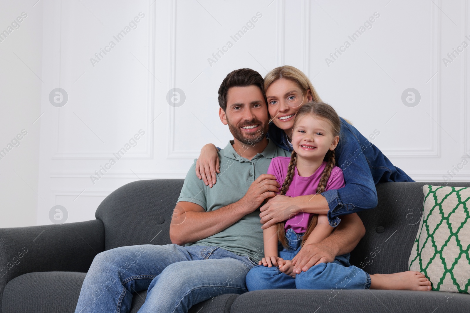 Photo of Portrait of happy family with child on sofa at home