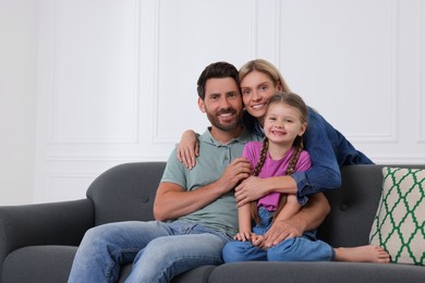 Photo of Portrait of happy family with child on sofa at home