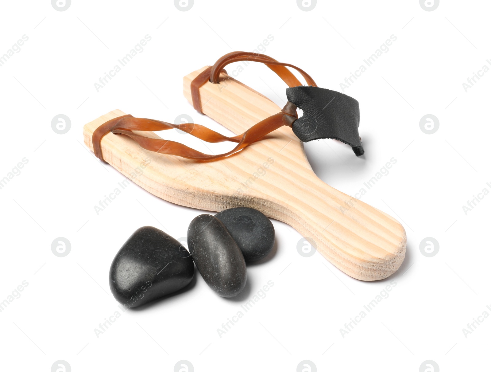 Photo of Wooden slingshot with stones isolated on white