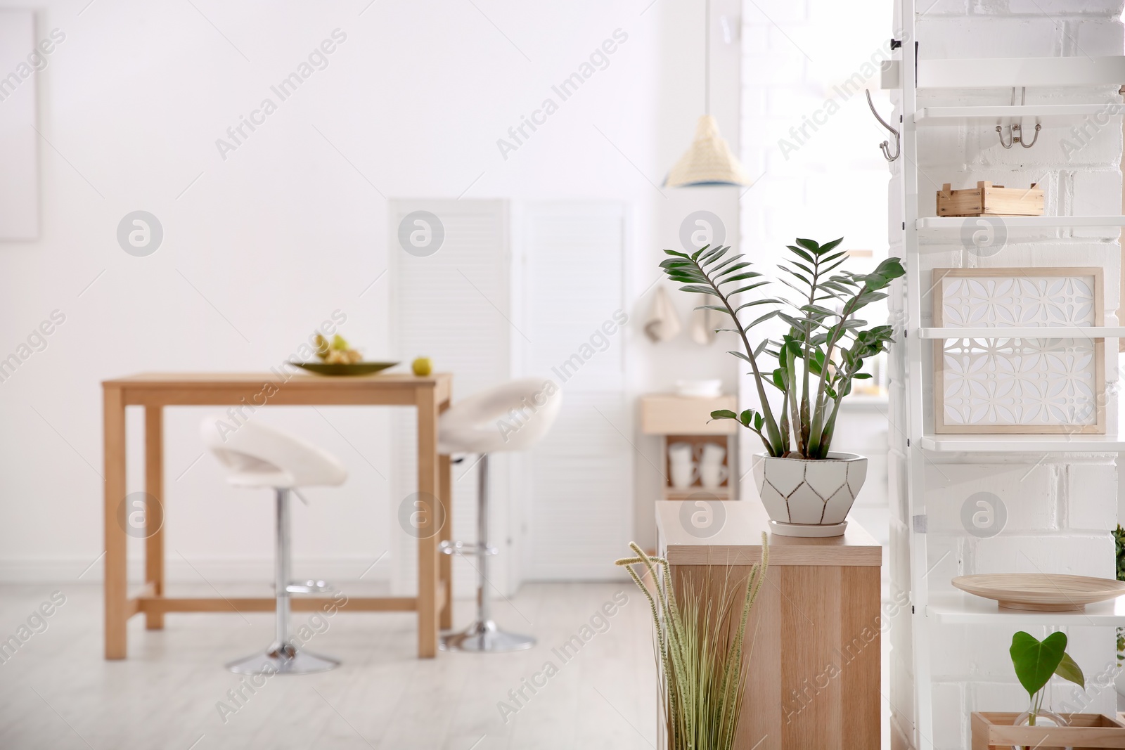 Photo of Modern eco style kitchen interior with wooden crates, houseplant and table
