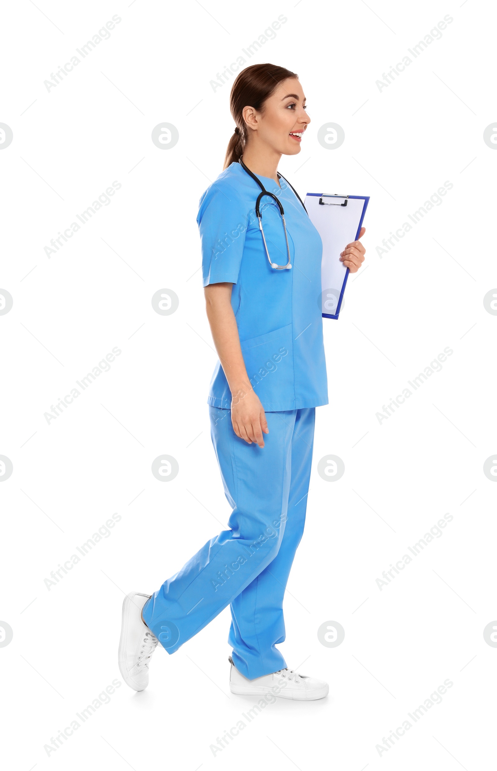 Photo of Full length portrait of medical doctor with clipboard and stethoscope isolated on white