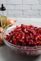 Photo of Delicious fresh vinaigrette salad on light grey table, closeup