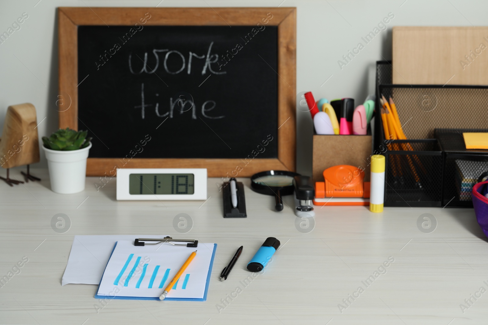 Photo of Business process planning and optimization. Workplace with small blackboard and different stationery on white wooden table