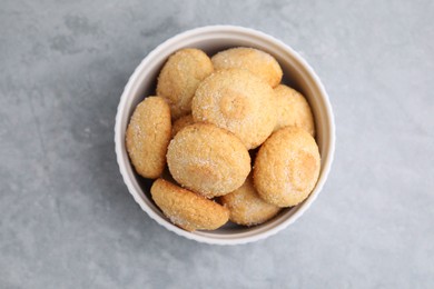 Photo of Tasty sugar cookies in bowl on grey table, top view