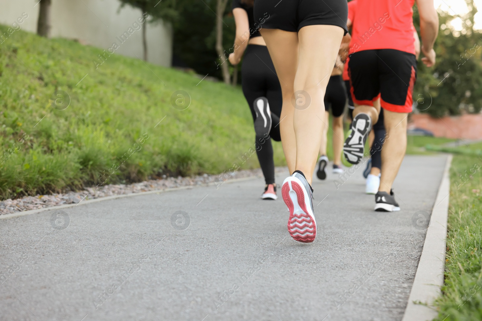 Photo of Group of people running outdoors, closeup. Space for text
