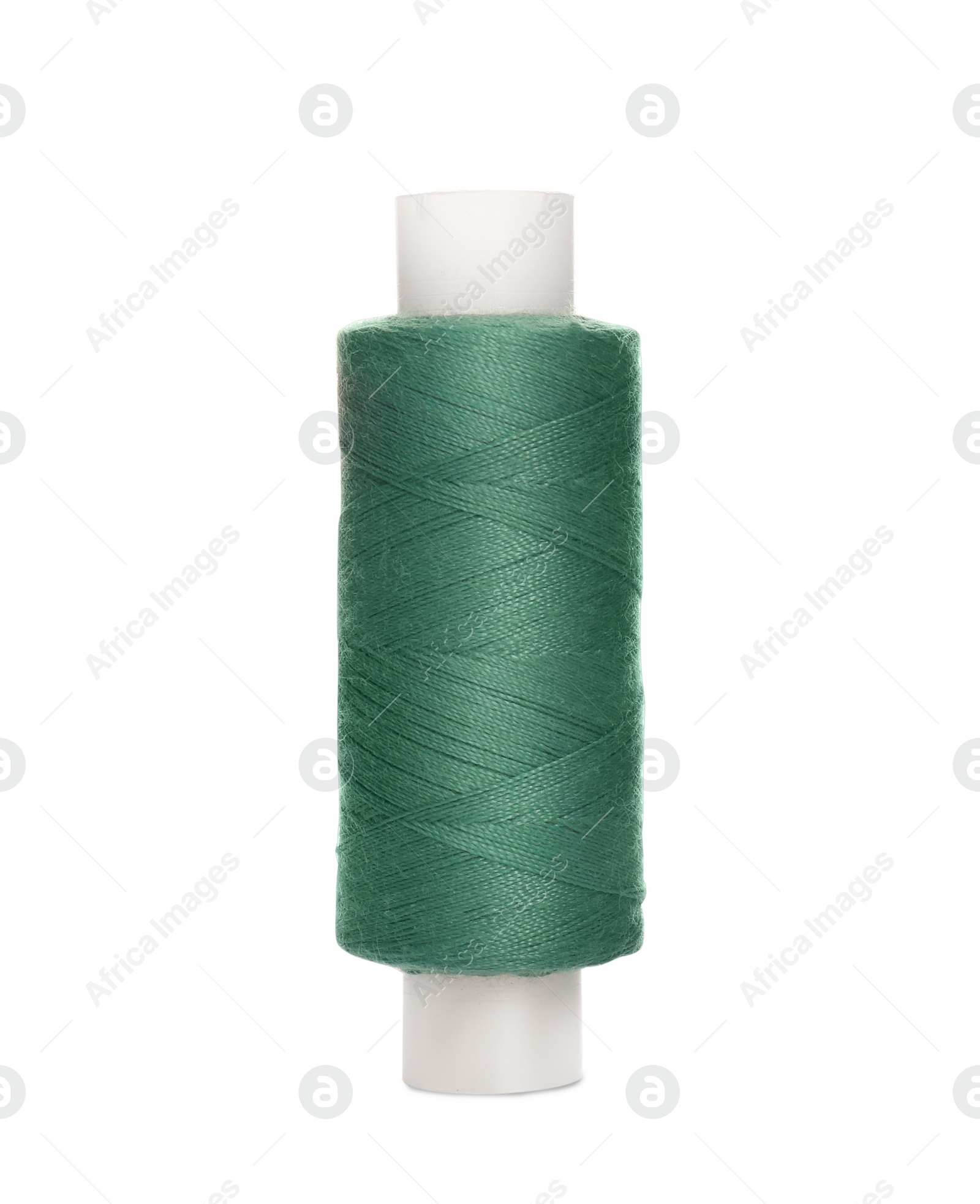 Photo of Spool of green sewing thread isolated on white