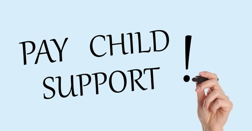 Image of Woman with marker and phrase PAY CHILD SUPPORT! on light background, closeup. Banner design