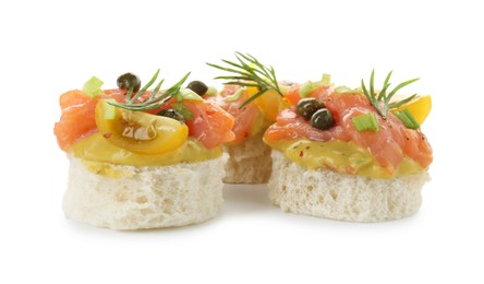 Photo of Tasty canapes with salmon, tomatoes, capers and herbs isolated on white