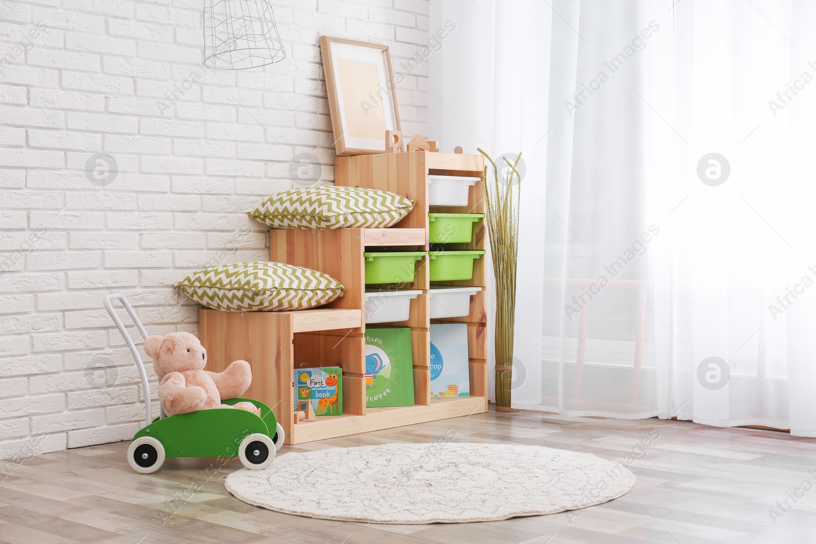 Photo of Modern eco style interior of child room with wooden crates near brick wall. Space for text