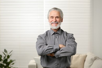 Portrait of handsome senior man at home