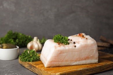 Composition with pork fatback on grey stone table. Space for text