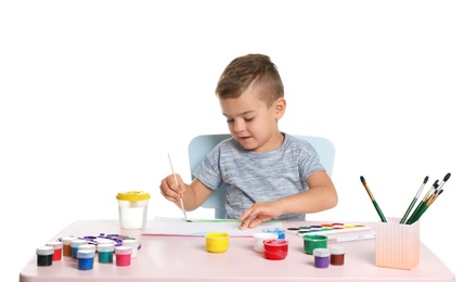 Cute child painting picture at table on white background