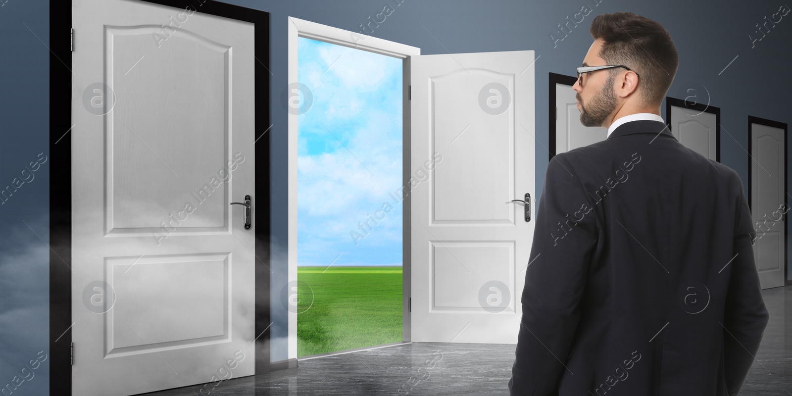Image of Young man standing in front of many doors. Choice concept