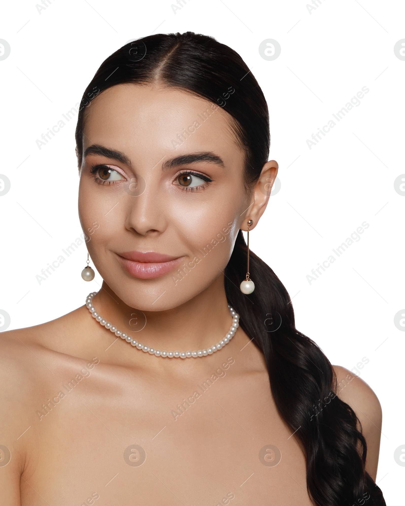 Photo of Young woman wearing elegant pearl jewelry on white background