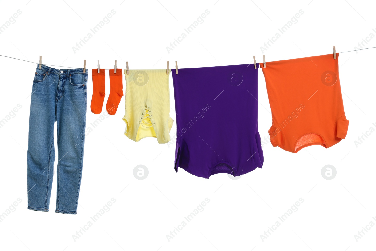 Photo of Different clothes drying on laundry line against white background