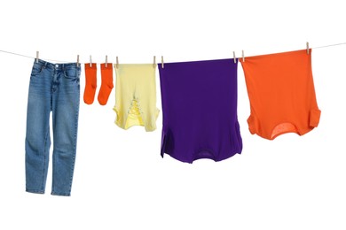 Photo of Different clothes drying on laundry line against white background