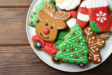 Photo of Different tasty Christmas cookies on wooden table, top view. Space for text