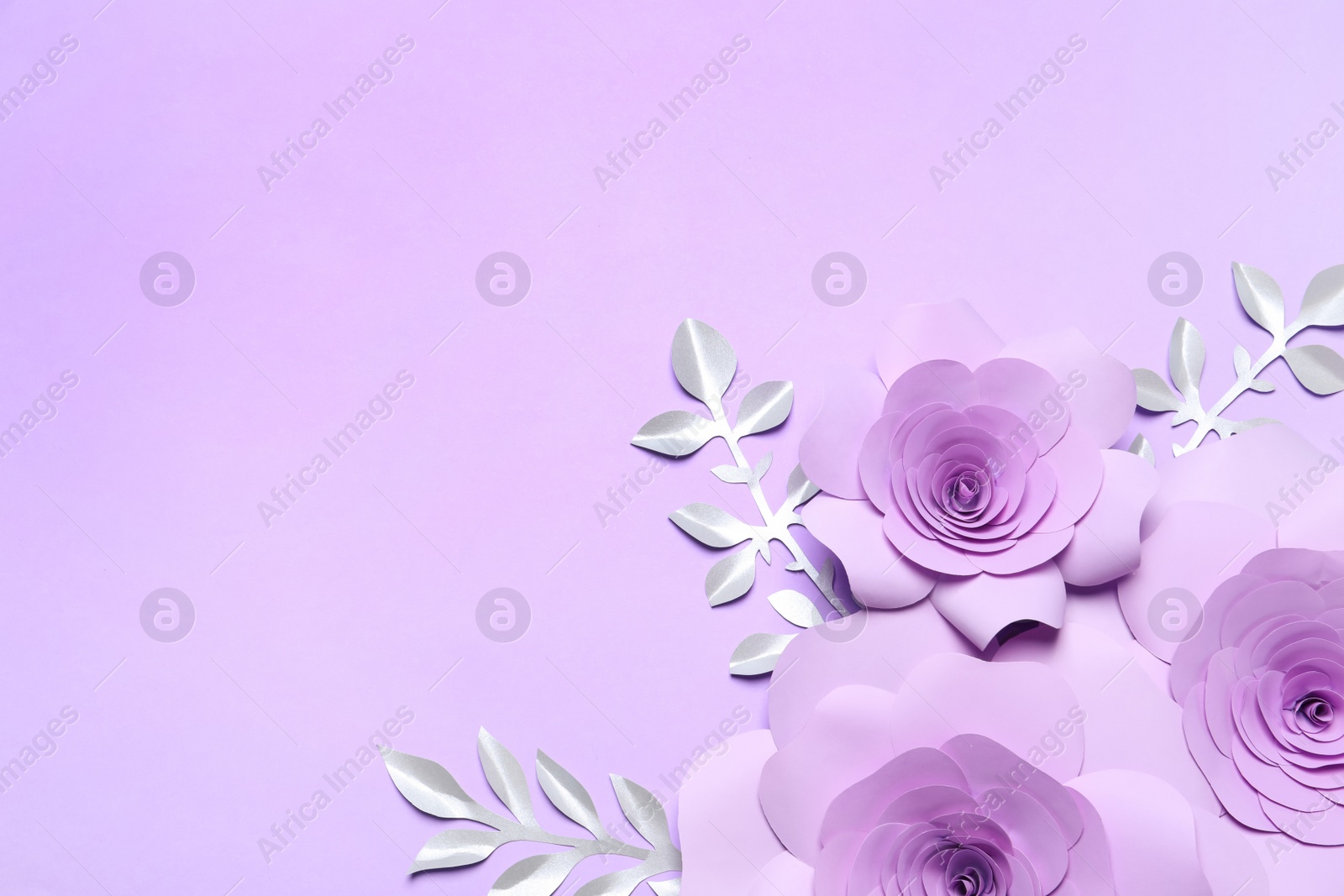 Photo of Beautiful flowers and branches made of paper on violet background, flat lay. Space for text