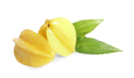 Ripe carambolas with green leaves on white background