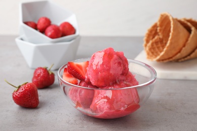 Photo of Yummy pink strawberry ice cream served on grey table