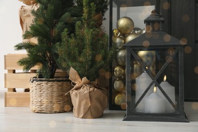 Photo of Beautiful fir trees and different Christmas decor indoors