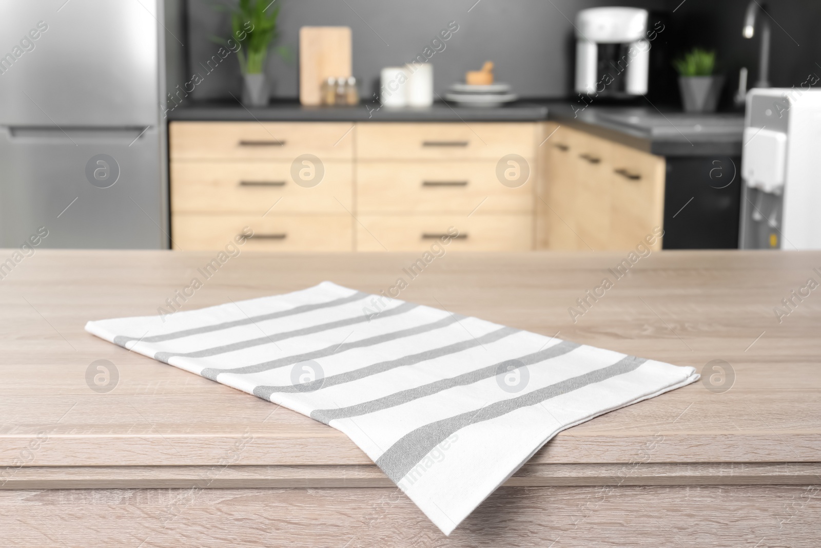 Photo of Napkin on wooden table in kitchen. Mockup for design