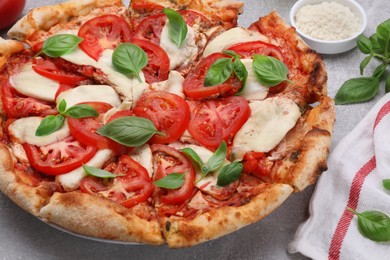 Photo of Delicious Caprese pizza on grey table, closeup