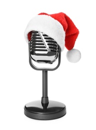 Photo of Retro microphone with Santa hat isolated on white. Christmas music